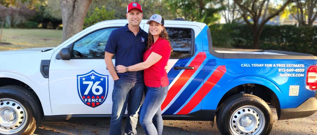 Tom and Kate Donnelly, owners of 76 FENCE Tampa, in front of their branded truck